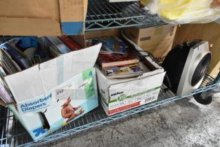 Boxed lot with Vornado fan, assorted books in diaper and paper boxes. Boxes show wear. Auction tag 212 visible.