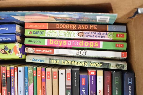 Box of assorted books including "Dodger and Me," "Best Friends and Drama Queens," "Boys are Dogs," and "The Lemonade War."