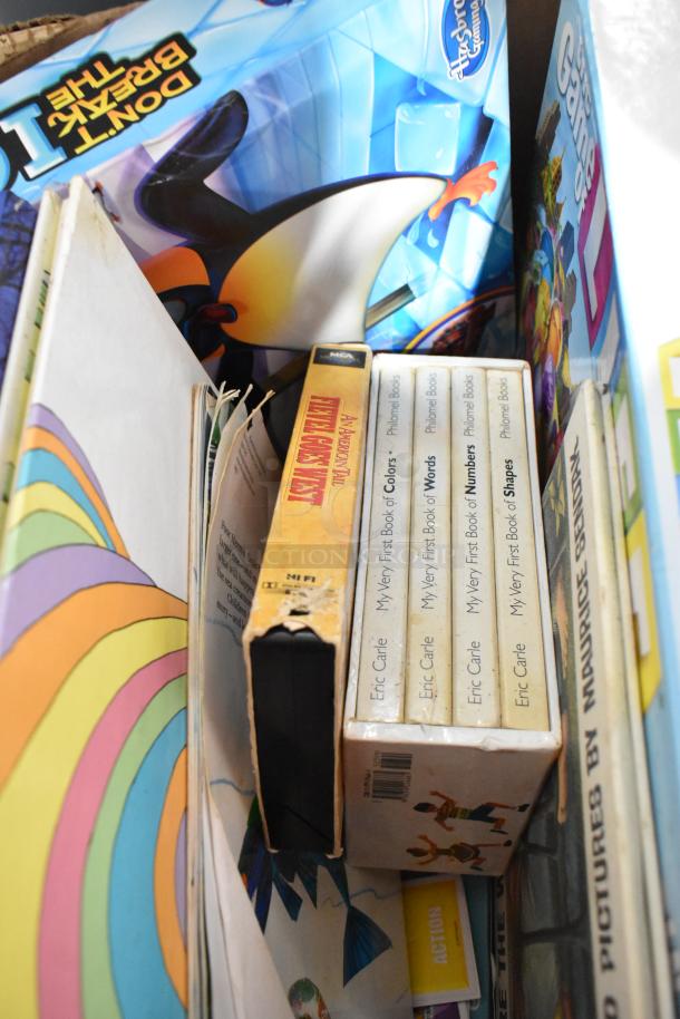 Tier lot of various items including Eric Carle books, Penguin-themed Hydrographics box, and additional mixed media.