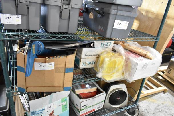 Tiered shelf with various items, including a blue caulk gun, binders, Xerox boxes, and yellow plastic wrap. Auction tags visible.