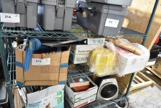 Tiered shelf with various items, including a blue caulk gun, binders, Xerox boxes, and yellow plastic wrap. Auction tags visible.