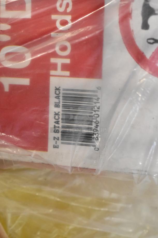 Tiered lot of various items including a caulk gun, binders, and jumper cables. Barcode with "E-Z Stack Black" visible.