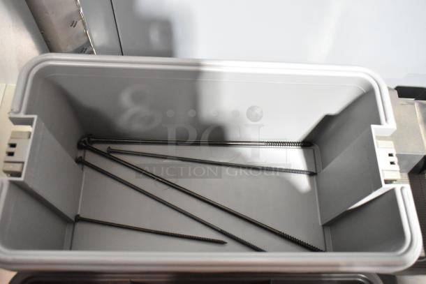 Two Craftsman gray poly toolboxes, open, containing several metal rods. Sturdy design, ideal for organizing tools.