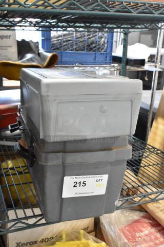 Gray poly tool box with visible locks and auction label, marked "215 QTY VX2" by PCIAuctions.com.