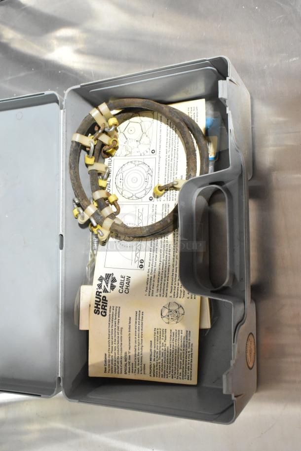 Gray poly toolbox containing Shur Grip cable chain kit with instructions. Sturdy handle, good condition, ideal for storage.