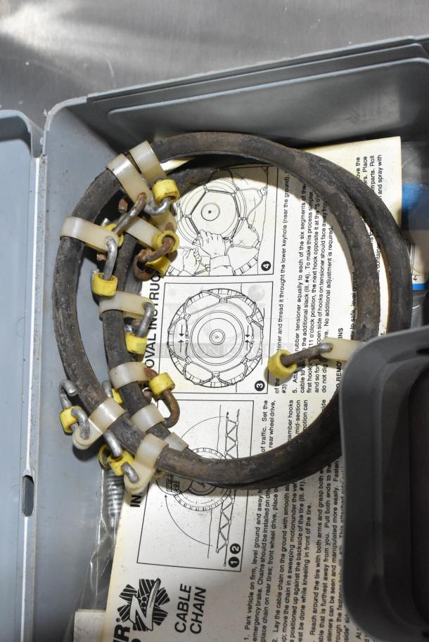 Gray poly tool box with Shur Grip cable chains, instructions visible. Good condition, includes 2 items for bid.