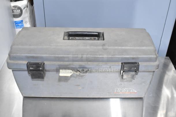 Gray Flambeau poly tool box with handle and Power Latch clasps. Includes Shur Grip. Visible wear, ideal for storage.