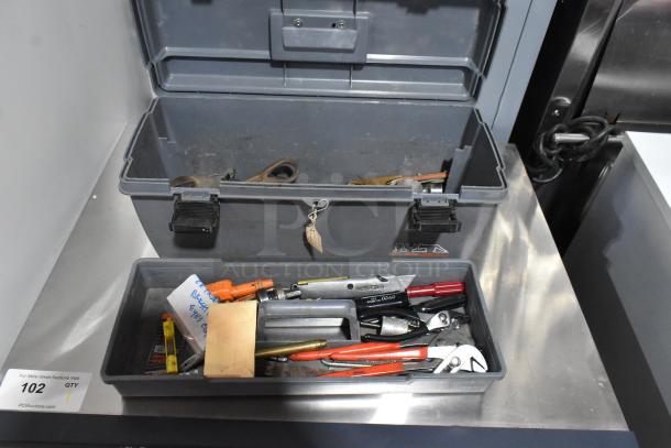 Gray poly tool box with various tools, including a Shur Grip tool. Slightly worn condition. Auction label reads "102 Qty".