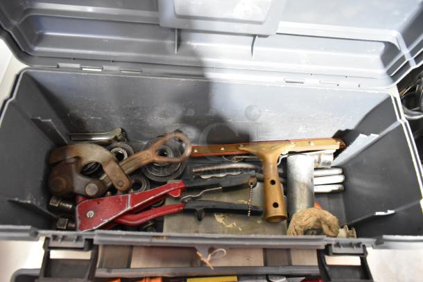 Gray poly tool box filled with assorted tools, including a red clamp and Shur Grip. Good condition for auction.