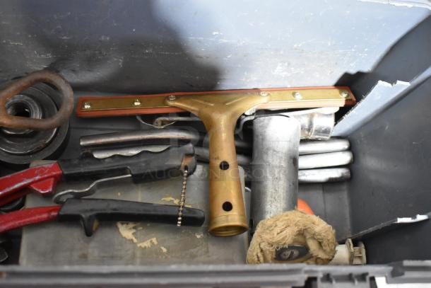 Gray poly tool box with assorted tools and Shur Grip, aged condition. Includes metal clamp, rubber grips, and brass handle.