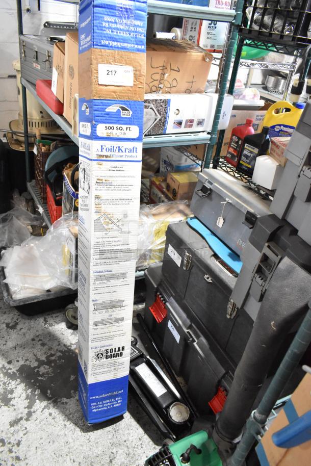 Foil/Kraft insulation roll, Craftsman 5,000 lb hydraulic jack, Weed Eater trimmer; new, boxed, and stored on metal shelves.