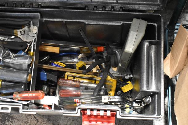Rubbermaid gray poly tool box with assorted tools, including pliers, screwdrivers, and a measuring tape. Good condition.