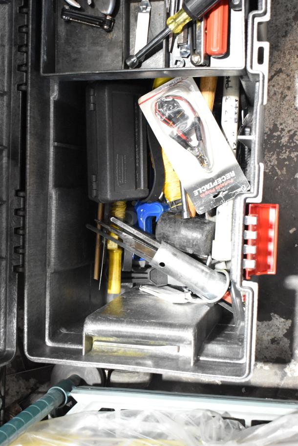 Rubbermaid gray poly tool box with assorted tools and accessories, showing organized compartments and contents.