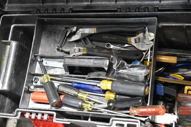 Rubbermaid gray poly tool box with assorted tools, including wrenches and screwdrivers. Tool box in good condition.