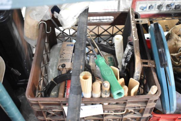 Tier lot of various items in a plastic crate, including tools, handles, and a ladder dolly. Shows wear.