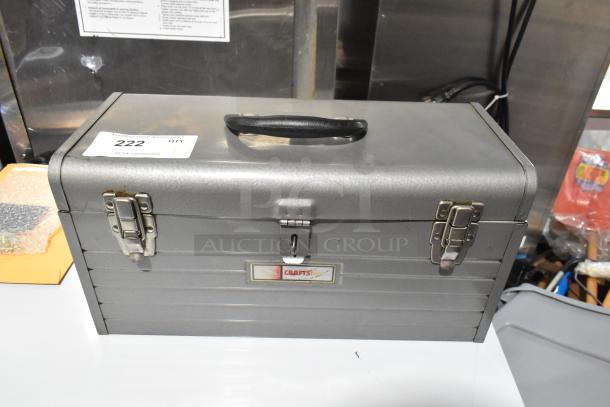 Craftsman gray metal tool box with latches and handle, slightly worn condition, label reads "Craftsman," auction tag "#222".