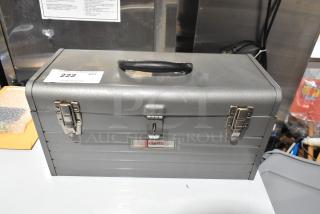 Craftsman gray metal tool box with latches and handle, slightly worn condition, label reads "Craftsman," auction tag "#222".