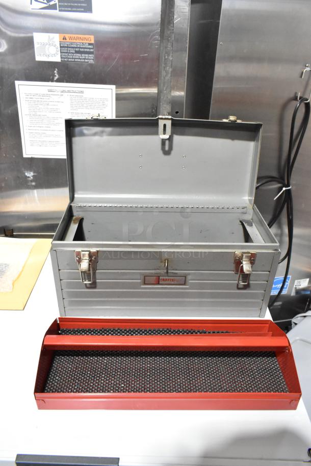 Craftsman gray metal tool box, open with red removable tray, sturdy latches, visible Craftsman label, gently used condition.