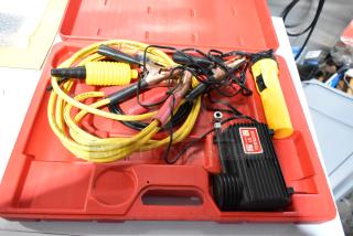 Deluxe air compressor in hard red case, includes yellow hose and clamps, appears in good condition with visible label.