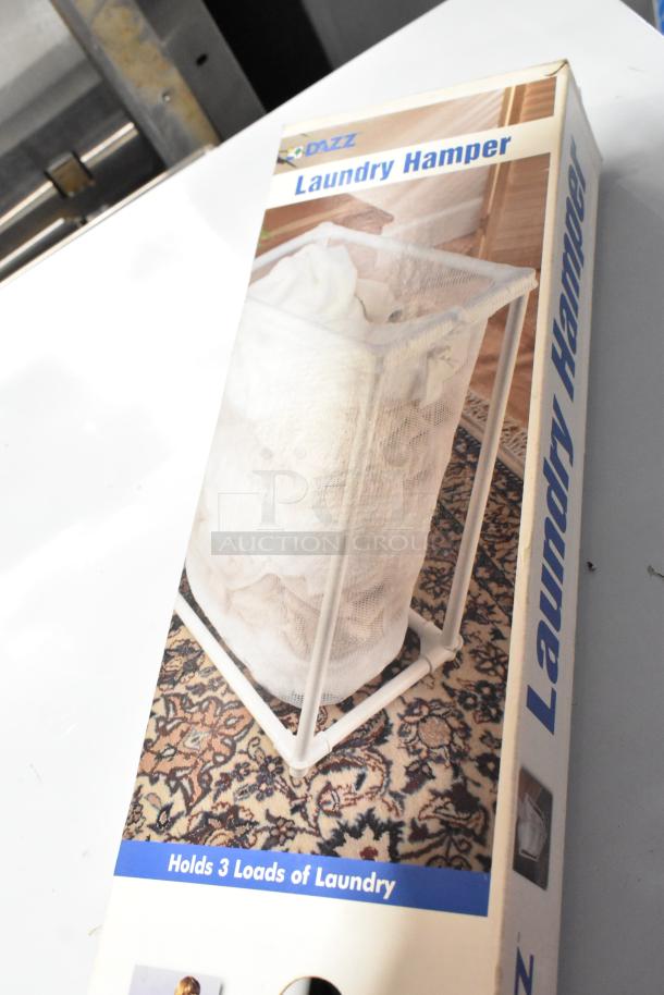 Brand new Dazz laundry hamper in box, holds 3 loads. Includes poly pour buckets and yoke vise. 3 items total.