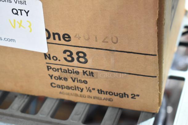 Cardboard box with "No. 38 Portable Kit Yoke Vise" text and "Assembled in Ireland" marking. VQ3 label visible.