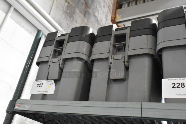 Two gray tool boxes with locking mechanisms, auction tags, and contents included. Sturdy, ideal for storage.