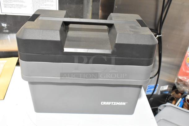Craftsman gray tool box with black lid. Includes three boxes with contents, featuring the Craftsman logo. Appears in good condition.