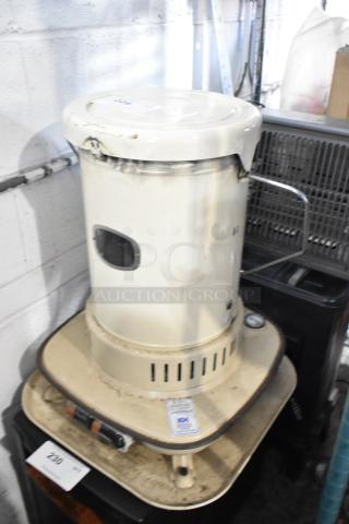 Corona 23-DK Portable Kerosene Heater, cream color, visible wear. Features handle, vent slots, and control panel. Model 23-DK.