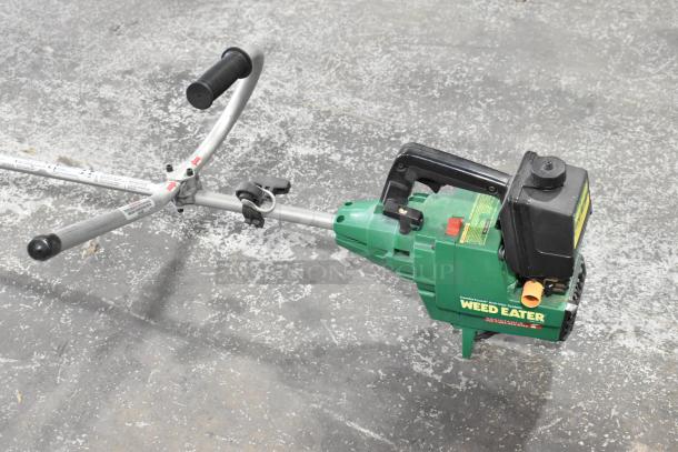 GTI 19T Weed Eater, green body, handle grips, visible labels, in used condition.