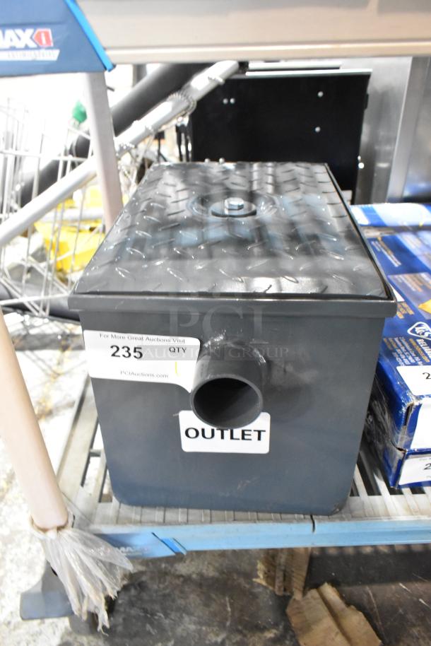 BRAND NEW scratch and dent Watts WD-4 8 lb. grease trap with outlet label, diamond-patterned lid, and auction tag 235.