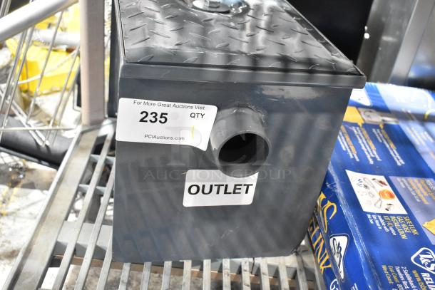 BRAND NEW Watts WD-4 8 lb. grease trap with minor scratches, outlet label visible, placed on a metal shelf.