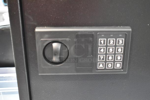 Brand new black steel key cabinet, 14 1/8" x 4 3/4" x 17 3/4", with electronic keypad lock, slight scratches.