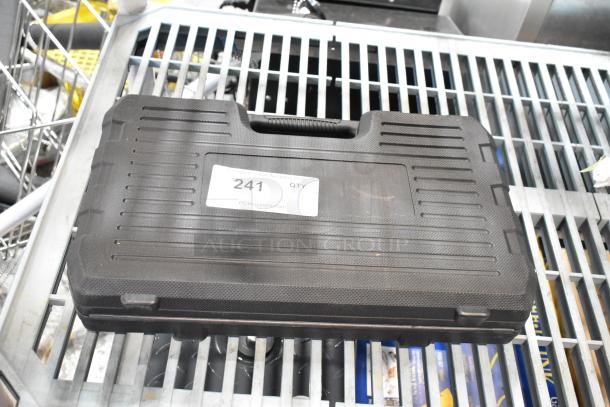 Black hard case with wrench kit inside, textured exterior, handle for easy carrying. Label reads “241 QTY” from PCIAuctions.com.