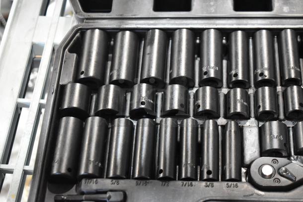 Black hard case with wrench kit, featuring various socket sizes. Clearly marked, organized layout. Excellent condition.