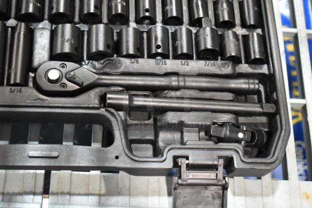 Black hard case with wrench kit, includes various sockets labeled with sizes, ratchet, and extensions in good condition.