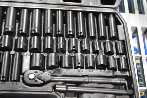 Black hard case wrench kit with various socket sizes, ratchet, and extensions. All items appear in good condition, organized.