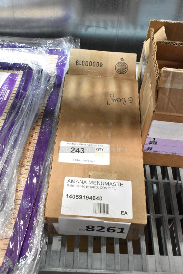 Three new scratch and dent items in boxes, including Amana Menumaster 59194640 Control Board. Box labels show auction details.