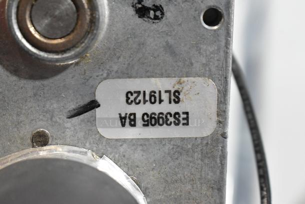 Metal component with label "E33995 BA SL19123," part of scratch and dent auction bundle including Amana, Lincoln, and Cleveland items.