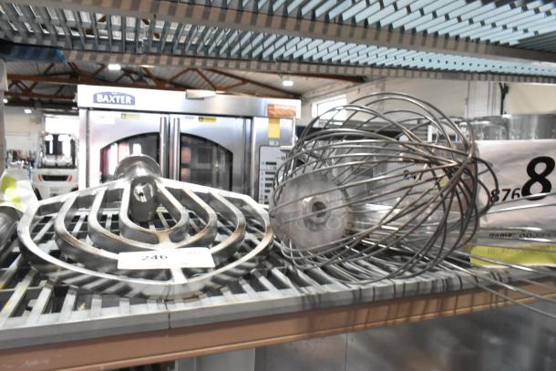 Three new scratch and dent attachments: paddle, whisk, and long-handled whisk on metal rack, auction setting.