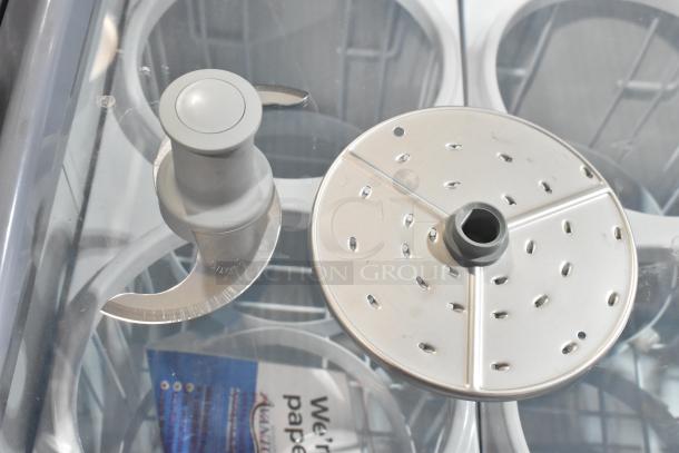 Robot Coupe 27055 Smooth "S" Blade and Robot Coupe 27577 5/64" Grating Disc displayed on a counter.