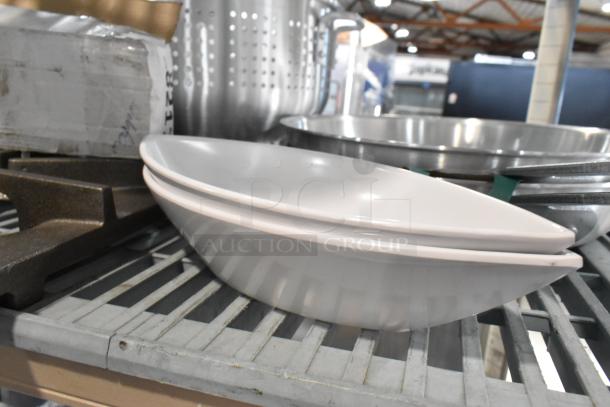 Assorted kitchenware items including aluminum steamer, steak knife, and colander, neatly displayed on a shelf.