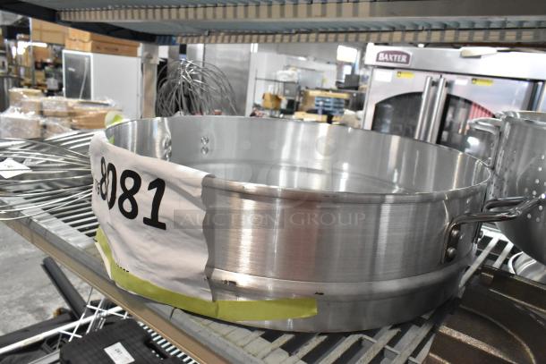 Large aluminum steamer with handles, new condition, on auction shelf labeled "8081".