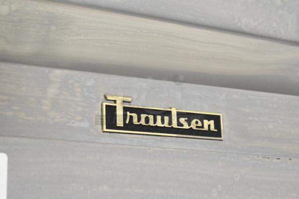 Traulsen logo on stainless steel surface of ADT132KUT-HHS commercial cooler/freezer, showcasing durability and brand quality.