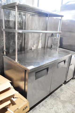 True TUC-48 stainless steel commercial 2-door work top cooler with 2 overshelves on casters, 115V, 1 Phase, used condition.