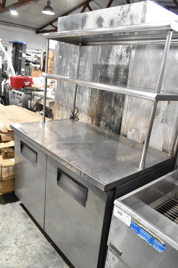 True TUC-48 stainless steel commercial 2-door work top cooler with 2 over shelves, on casters. 115V, 1 phase, good condition.