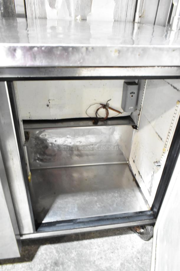 True TUC-48 2-door stainless steel cooler, 2 over shelves, commercial casters, 115V, 1 Phase, used condition.