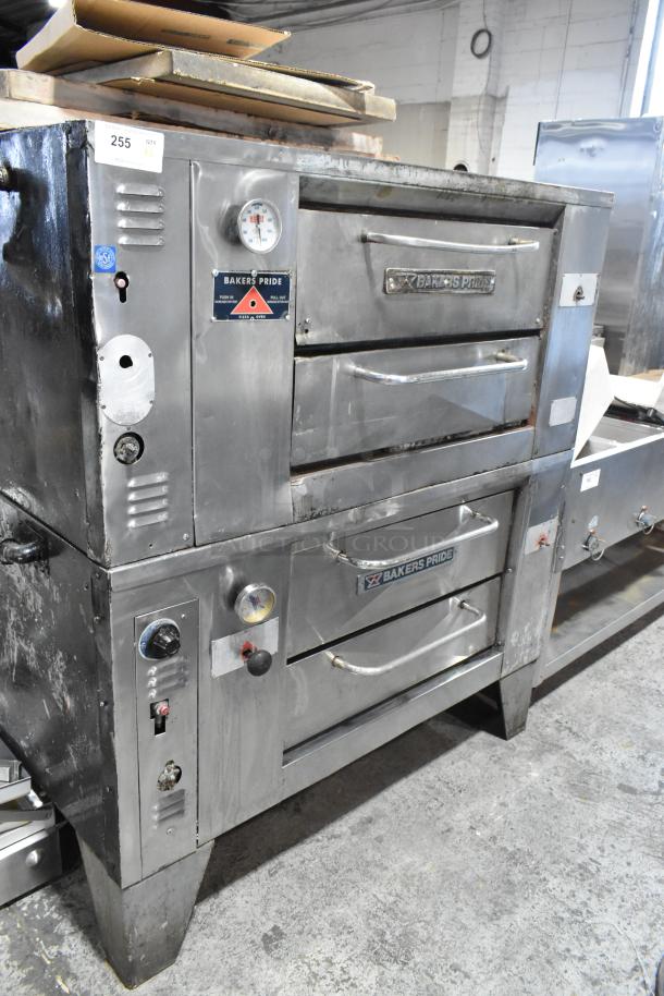 "2 Bakers Pride stainless steel commercial gas pizza ovens with cooking stones, visible gauges, fair condition."