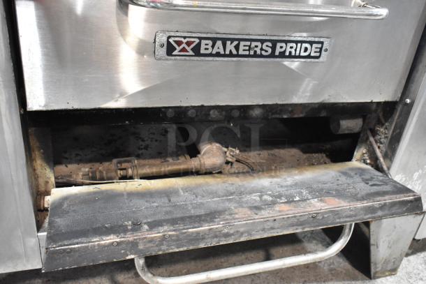 2 Bakers Pride stainless steel commercial gas single deck pizza ovens with cooking stones, used condition. Brand label visible.