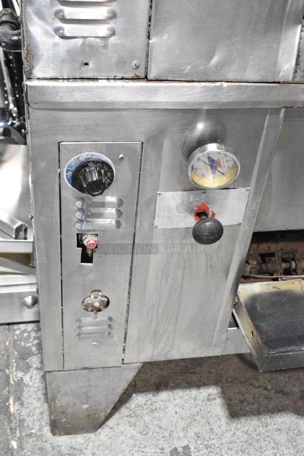 2 Bakers Pride stainless steel gas pizza ovens with cooking stones, visible controls, and temperature gauge. Used condition.