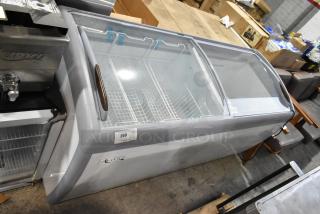 Avantco 360DFC20HCL ice cream freezer, curved glass top, metal baskets, commercial casters, new scratch and dent, 115V, tag 269.
